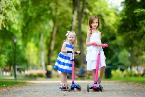 kids playing with their beautiful scooter