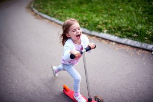 Scooting is fun for this girl. She looks happy because of this experience. 