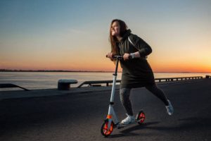 a girl riding a moped