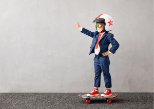 A child wearing protective gear while riding his board. 