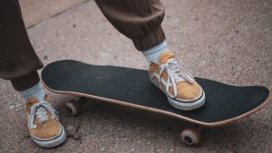 A skateboarder with his or her skateboard.