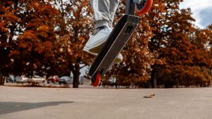 Witness an awe-inspiring spectacle captured in a single frame—a scooter takes flight, propelled by the execution of a remarkable trick. Amidst the picturesque beauty of an autumnal park, it soars gracefully, defying gravity. This snapshot encapsulates the exhilarating fusion of athleticism and natural splendor, a testament to the harmony between human skill and the world around us.