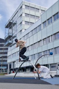 A man executing scooter tricks.