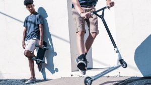 An active teenager showcasing their skills on a stunt scooter. 