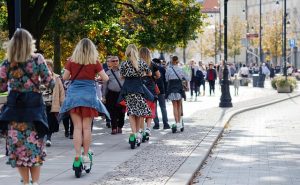 Young teens on scooters.