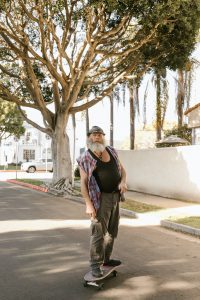 An elder guy improving balance on skateboard