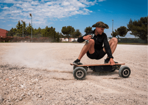 A person making a fun ride on his longboard