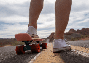 A skater wearing an appropriate skateboard shoes rides an appropriate off road skateboard for safety skateboard ride. 
