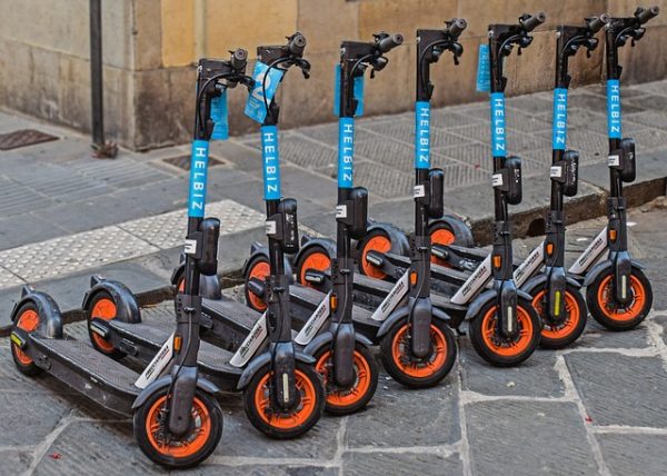 A row of scooters parked on the street