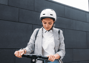 A woman riding a scooter.