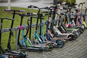 Scooters parked beside the street with different scooter Locks 