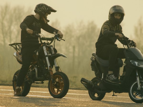 two men wearing protective helmets for safety purposes while going on a ride