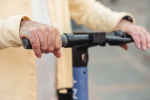 A man stopping his scooter