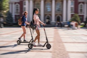 Scooter models for adventure. Girl riding her adventure scooter.