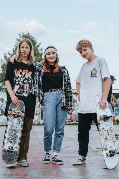three teens posing for a picture before skateboard riding