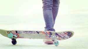 A picture of a person's leg and a longboard