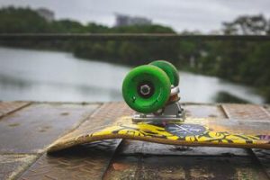 Skateboard with a green wheel. 