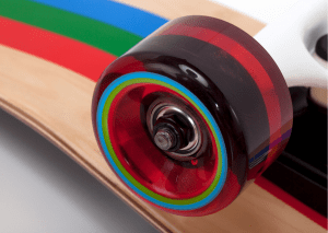 This is a picture of a zoomed skateboard featuring a colorful tire. 