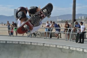 A skateboard rider doing skateboard riding tricks in the skatepark. 