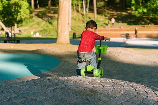 A little toddler with his scooter