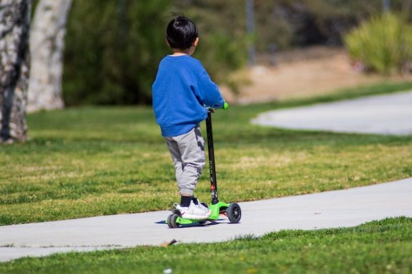 Toddler riding a scooter 