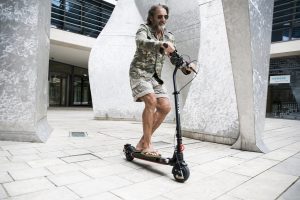 He is enjoying his scooter and scootering experience. 