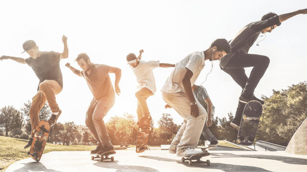 A group of men doing street skateboarding. They are having fun while doing the different tricks.