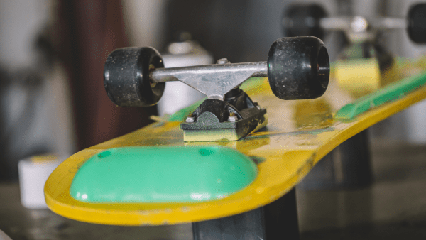 A yellow street skateboard with black wheels.