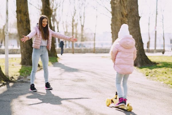 Siblings with their scooters