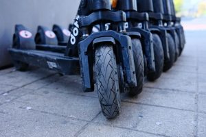 A row of sleek black scooters lined up in perfect formation.