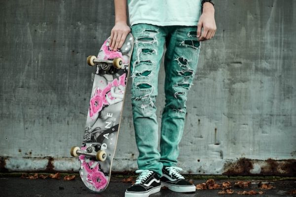 Man holding a customized skateboard.