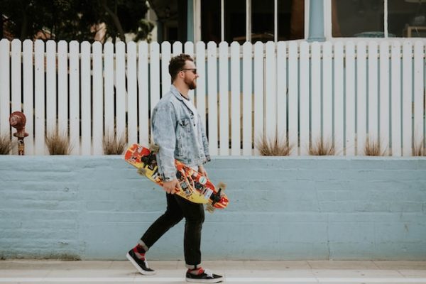 Man walking down with a skateboard.