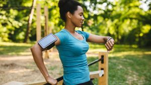 A lady takes a break from her afternoon ride, looks focused on her tracking device.