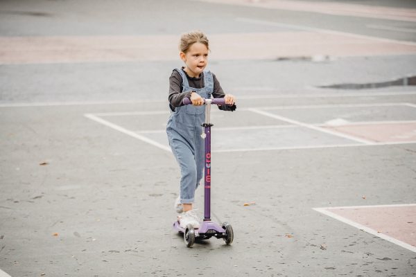 girl riding a scooter. kids should scooter because a scooter offers many benefits.