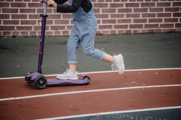 A child riding a scooter.