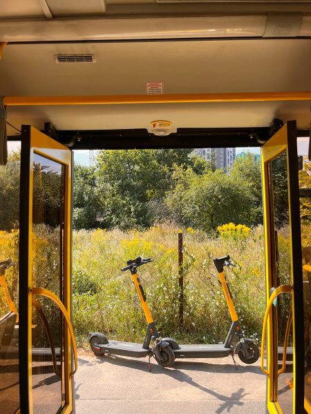 Two yellow scooters parked outside