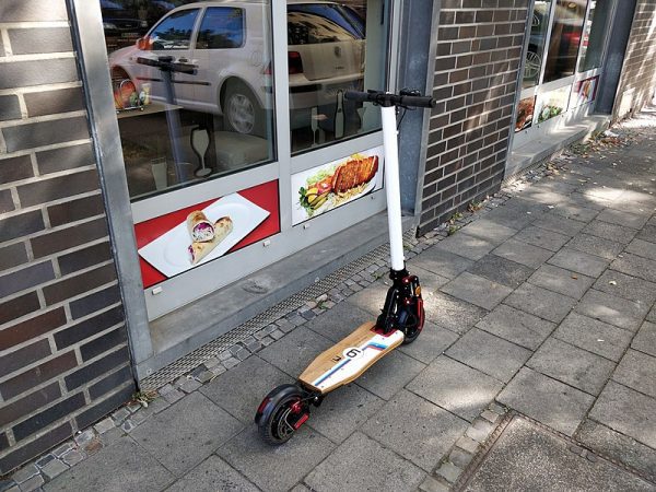 Scooter parked outside a restaurant