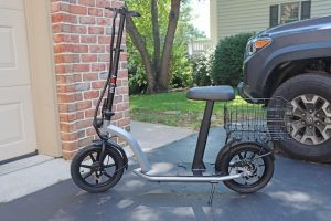 A seated electric scooter where you can sit. An electric scooter is convenient.