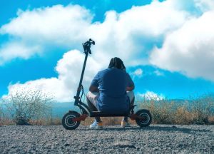 Man sitting on a scooter with his back facing