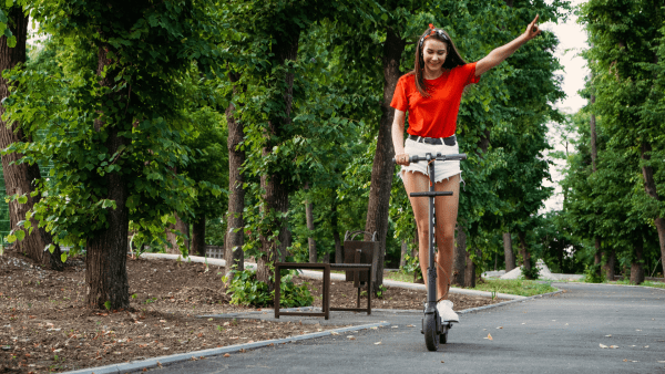 A girl practicing safely in her scooter. 