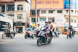 Passengers on scooters on the street