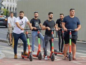 Men using scooters for recreation.
