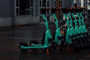 Colorful array of micro-mobility vehicles parked along a city street, offering a convenient and eco-friendly mode of urban transportation.