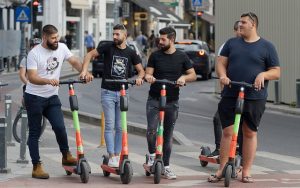 Group of men with their scooters.