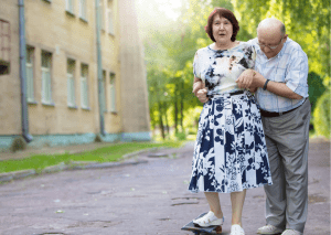 an elderly couple trying to learn and teach each other how to skate