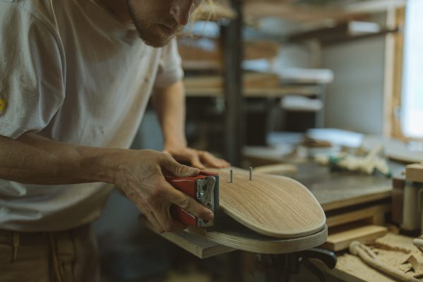 Man crafting a skateboard. Maintaining it is important.