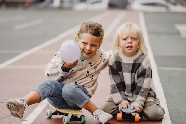 Two kids skateboarding safey.