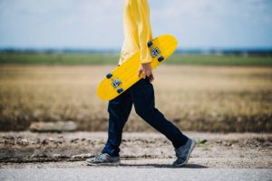 A man in a yellow shirt with his board