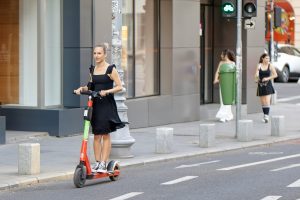 best electric scooter accessories: Woman having the best ride with her electric scooter and best accessories.