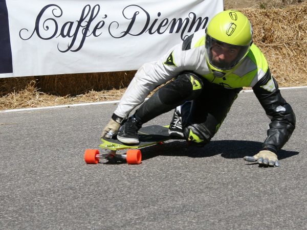 A skateboarder with wrist guards.